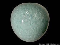 Top-down view of the vase showing details of embossed floral patterns.