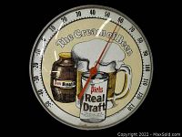 Front view of vintage circular thermometer with Piels Real Draft beer advertisement showing temperature dial and graphics.
