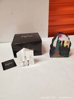 Vintage painted NYC skyline decorative piece with colorful sky and iconic landmarks including Statue of Liberty and Twin Towers.