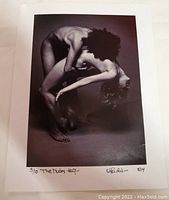 Black and white 8x10 photograph of a nude figure bending backwards, signed by artist with edition number 3/10 and date 8/14.