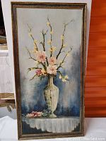 Full view of the framed oil painting showing floral still-life.
