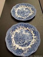 Two 9.25 inch JG Meakin plates with detailed blue and white Romantic England design showing Haddon Hall, Derbyshire. Plates have scalloped edges with floral border pattern.