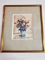 Full view of vintage framed watercolor floral painting with gold frame and beige mat.
