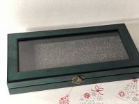 Top view of the closed wooden display box showing the glass lid and latch.