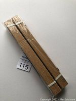 Two packs of 8x10 teak wood frames in shrink wrap, showing light wood texture and thickness