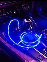Blue LED illuminated Micro USB cable plugged into car charger.