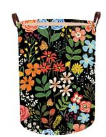 Front view of XL laundry basket displaying colorful floral pattern on black background with leather handles attached on both sides.