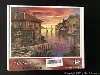 Front image of the box showing the Mediterranean harbor sunset scene with sailboats and buildings on the water.