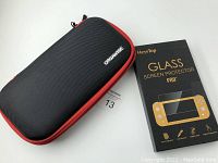 Closed black Nintendo Switch carrying case with red zipper trim beside box of HeysTop Glass Screen Protector Pro for Nintendo Switch.