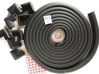 Rolled black foam edge guard strip with eight corner bumpers around it, plus adhesive tape visible.
