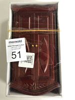 Front view of the wooden dollhouse cabinet in original box with double doors closed, showing overall height and width.