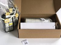 Boxed accessory kit with side brushes, HEPA filters visible inside clear plastic packaging.