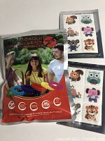 Photo showing package of mosquito repellent bands in colorful coil form and two sheets of animal stickers showing owl, elephant, tiger, mouse, and pig designs.