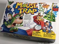 Front of Mouse Trap family board game box showing colorful cartoon characters and age recommendation.