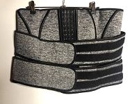 Front view of grey waist trainer with hook-and-eye closures and black adjustable Velcro straps.