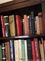 Shelf of assorted English language and art books, spines visible showing various titles related to English grammar, linguistics, and art.