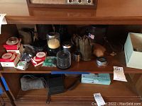 Shelf view with Leitz boxes, lens canisters, jars and pouches