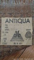 Close-up of label showing brand Antiqua by Hayim & Company, 100% wool, made in France, size 3'1" x 6'2"," dry clean only