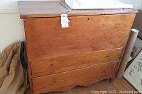 Front and side views of the wooden storage cabinet showing size, shape, and condition with tags visible.