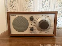 Front view of the Tivoli Audio Model One radio showing the speaker, knobs, and frequency dial