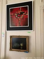 Photo showing both artworks hanging on a wall, the abstract cloisonné art above and the fruit painting below.