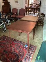 Two folding card tables side by side in room interior.