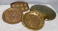 Chinese brass gong large and three decorative plates/trays including one with paint detail and two brass engraved plates