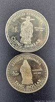 Front view of two Canadian collector coins, Ching Dollar and Tang Dollar, dated 1977-1978, showing detailed figures and inscriptions