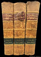 Front view of three volumes upright showing spine labels and raised band details