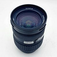 Front view of Olympus 14-54mm lens showing lens glass and Olympus branding.