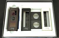Ring Doorbell Pro unit with three alternate faceplates in different colors inside the packaging box.