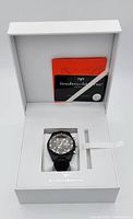 Open white TechnoMarine presentation box showing watch on cushion and original documentation card