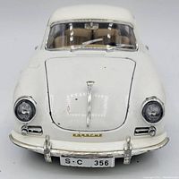 Front view of white 1961 Porsche 356B model showing chrome details and license plate S-C 356.