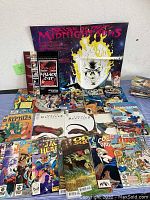 Wide shot of a variety of comic book titles and a Rise of the Midnighters poster on display