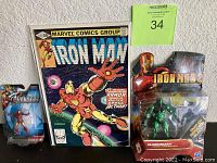 The lot showing the vintage Iron Man comic book and two sealed action figures, one from Iron Man 2 Ceramic Series and one Marvel Avengers Iron Man figure.