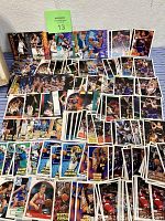 Photo showing a large spread of over 400 NBA trading cards arranged on a surface, depicting various players and styles.