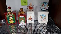 Four boxed vintage Christmas ornaments displayed, three Hallmark Keepsake and one Carlton Heirloom, from different years including 2001, shown in original packaging.