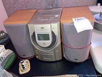 Front view of JVC stereo system with both attached wooden speakers shown on either side.