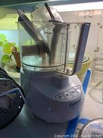 Photo of the Cuisinart PowerPrep Plus food processor base unit with clear plastic work bowl and handle.