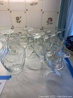 Overview of glassware items showing martini, brandy, wine glasses, and vase