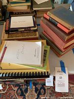 Image showing stacks of books with visible labels 'Music Books' and 'Beginner's Guide to Oriental Rugs'
