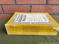 Stack of six 1938 National Geographic magazines with yellow borders and visible volume and issue numbers.