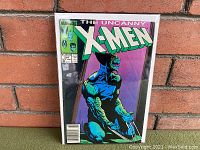 Front cover view of The Uncanny X-Men #234 comic book featuring blue-skinned Wolverine character crouching