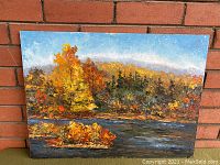 Original oil painting showing full fall landscape scene with colorful trees, water, and background hills against blue sky.