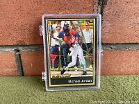 Front view of 1991 Michael Jordan Ballstreet baseball card in protective plastic case showing full card with image and text.