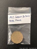 Photo of the 1953 Great Britain Three Pence coin sealed in a small plastic bag with handwritten label.