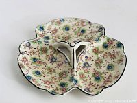 Top view of the divided porcelain serving dish showing the floral pattern and three leaf-shaped compartments.