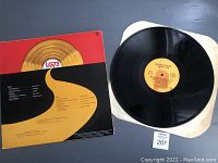Vinyl record partially out of its protective sleeve showing 'Solid Gold Gift' label and LG73 logo.