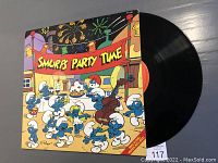 Front cover of vinyl record showing Smurfs characters and 'Smurfs Party Time' banner.