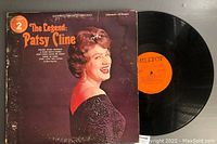 Front of album cover for 'The Legend: Patsy Cline' with a visible water stain along the edge and one vinyl record partially pulled out